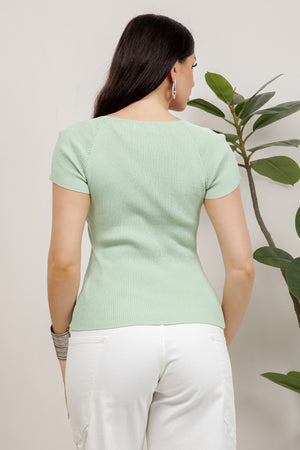 Ribbed short sleeve knit top with v-neckline and ornamental metal button details.