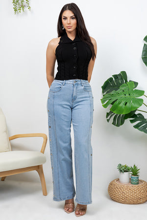 Lotas a knit top featuring large tone-on-tone buttons and textured side details. designed with a versatile neckline