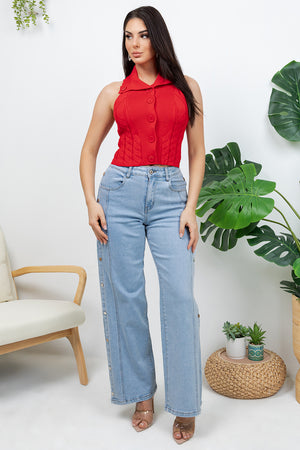 Lotas a knit top featuring large tone-on-tone buttons and textured side details. designed with a versatile neckline