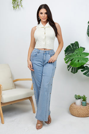 Lotas a knit top featuring large tone-on-tone buttons and textured side details. designed with a versatile neckline