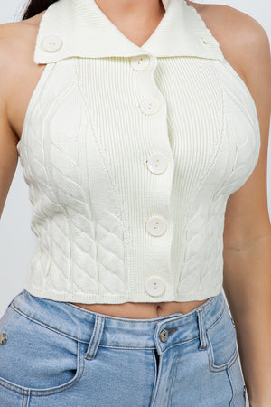 Lotas a knit top featuring large tone-on-tone buttons and textured side details. designed with a versatile neckline