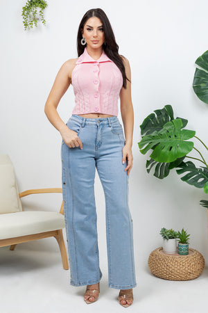 Lotas a knit top featuring large tone-on-tone buttons and textured side details. designed with a versatile neckline